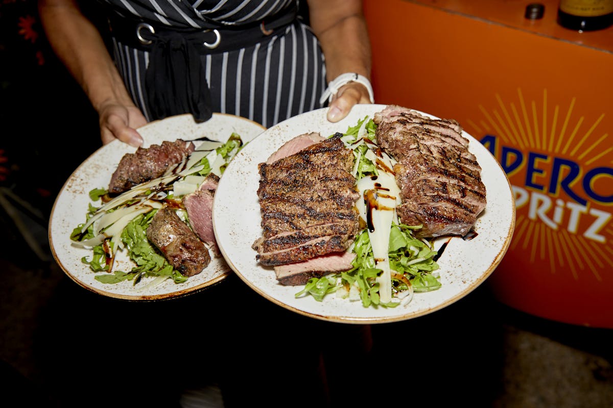 a person sitting at a table with a plate of food