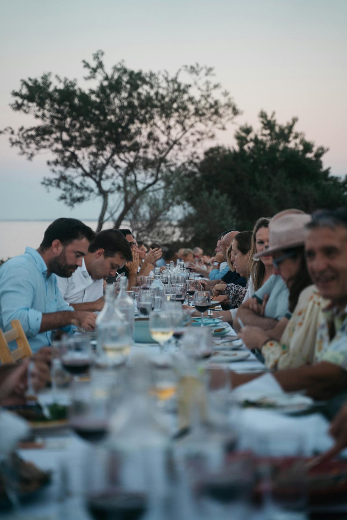 a group of people sitting at a table with wine glasses