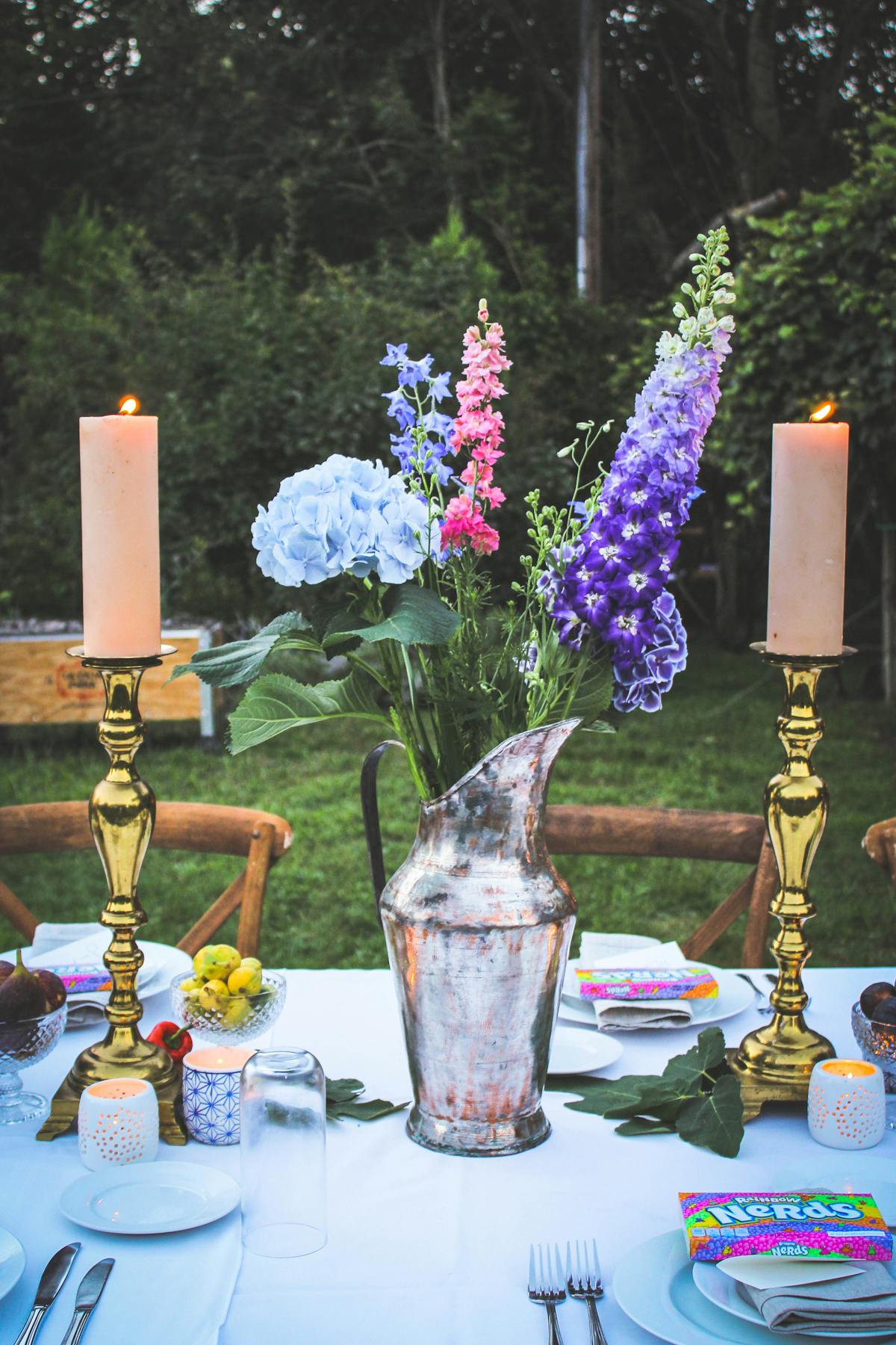 candles and a vase of flowers on a table