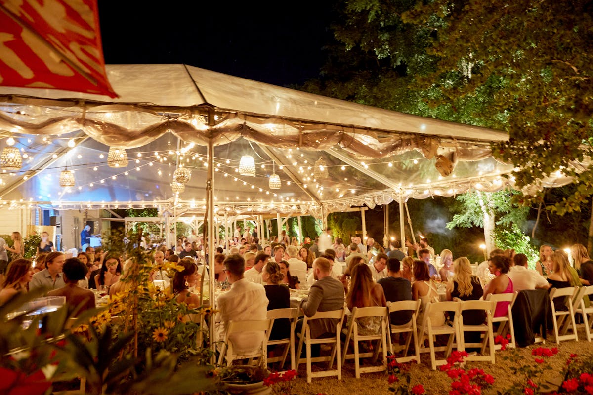 a group of people sitting at a table in front of a crowd