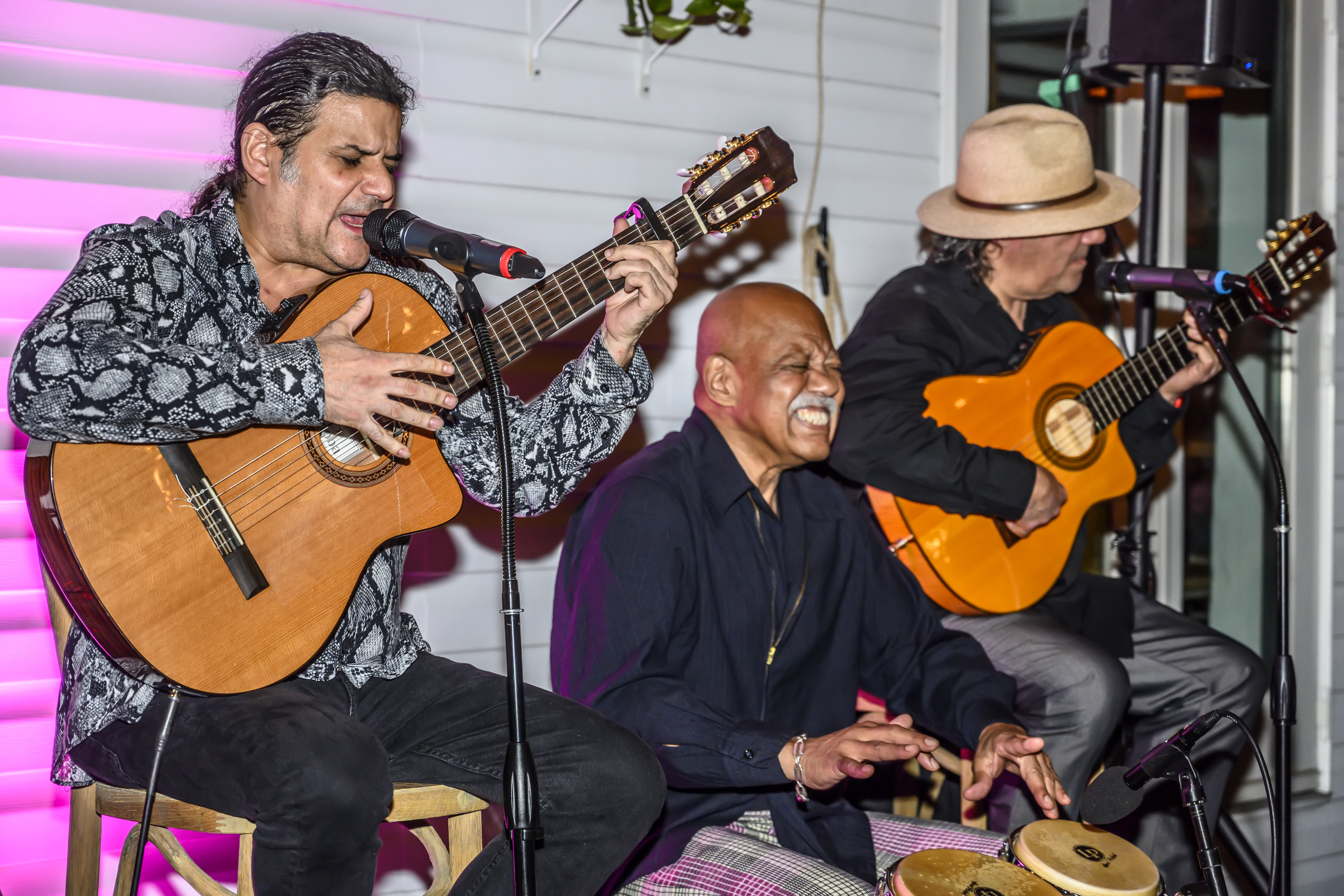 a close up of a guy playing a guitar