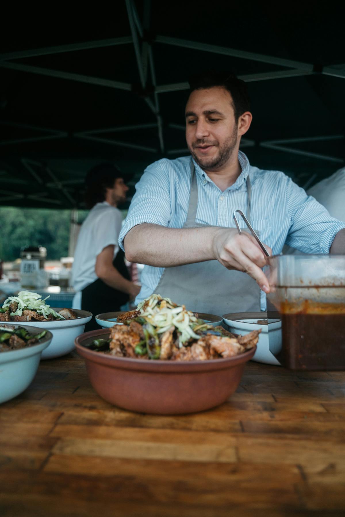 a person cooking food in a bowl