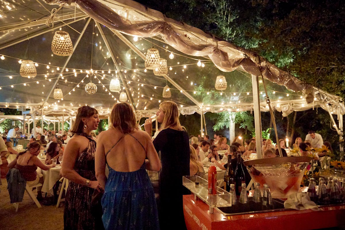 a group of people standing in front of a carousel