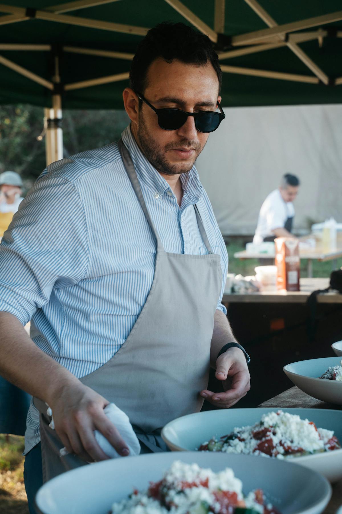 a man sitting at a table with a plate of food