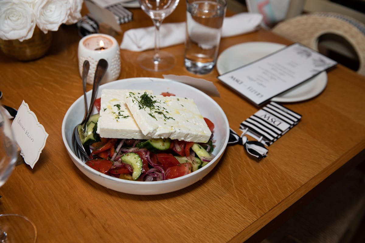 a wooden table topped with plates of food on a plate