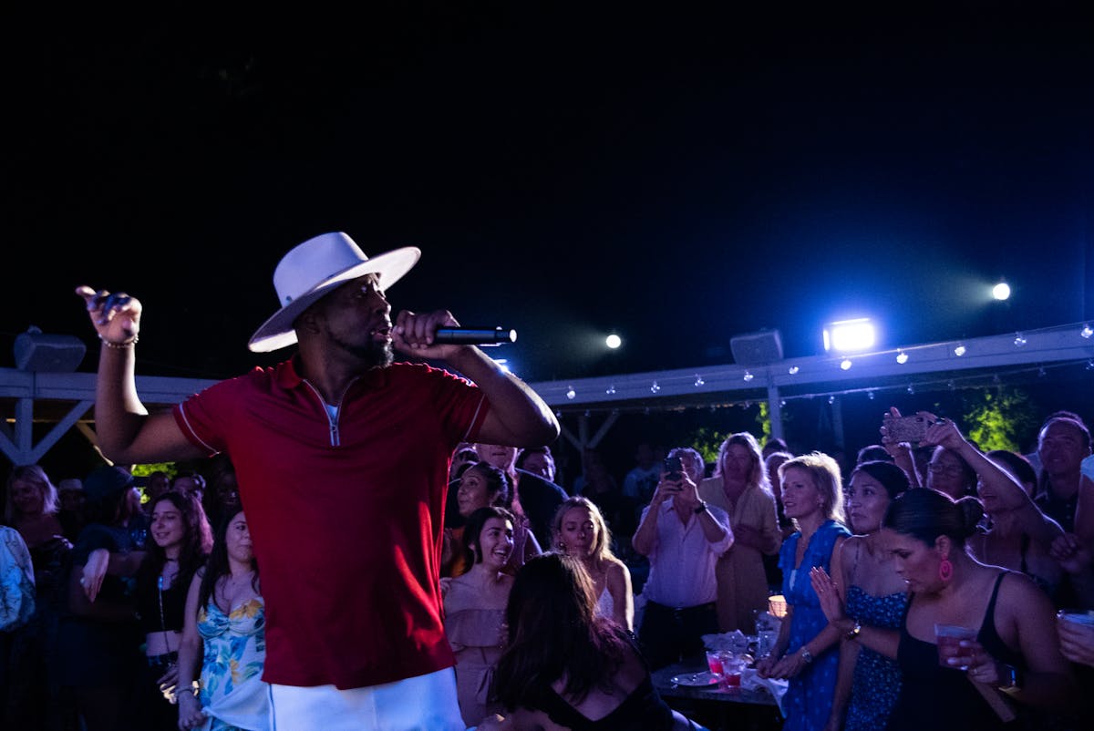 a man standing on a stage in front of a crowd