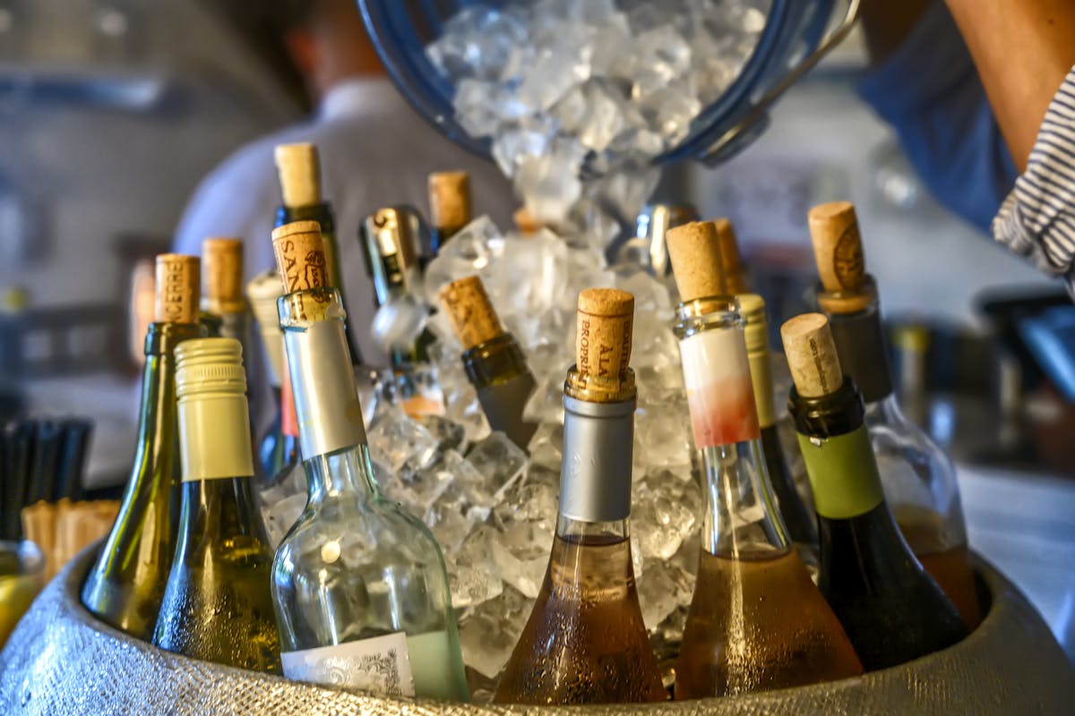 bottles of alcoholic drinks on a bucket of ice