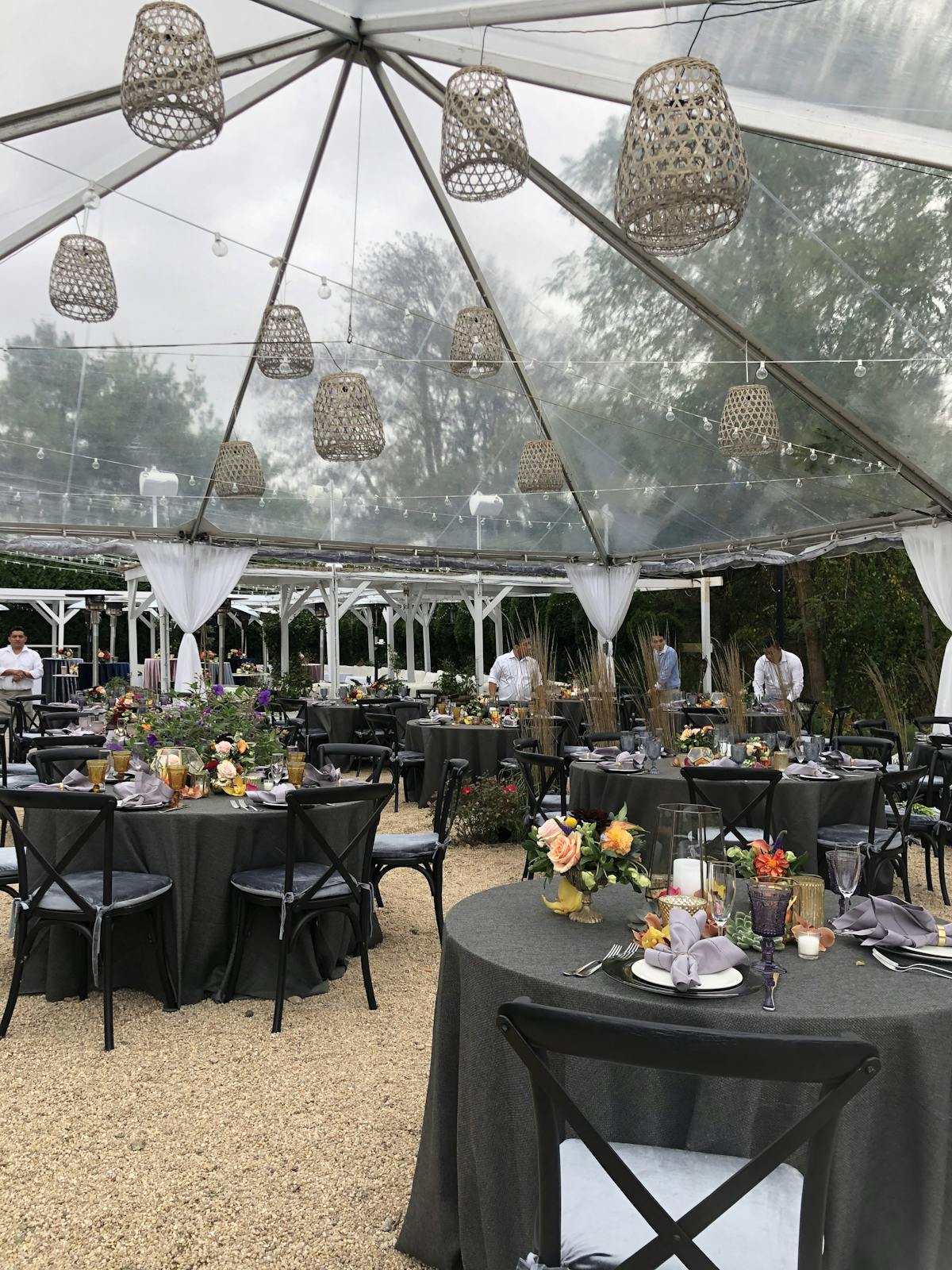 a group of people sitting at a table with an umbrella