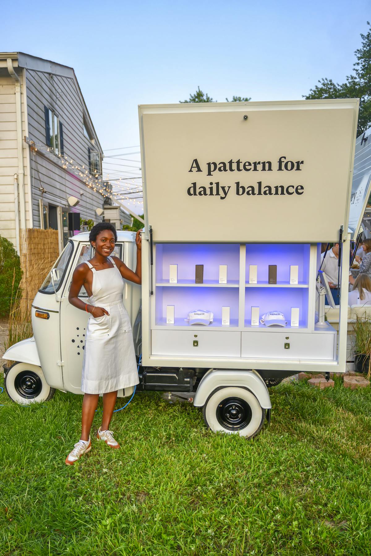 a woman posing near a display cart