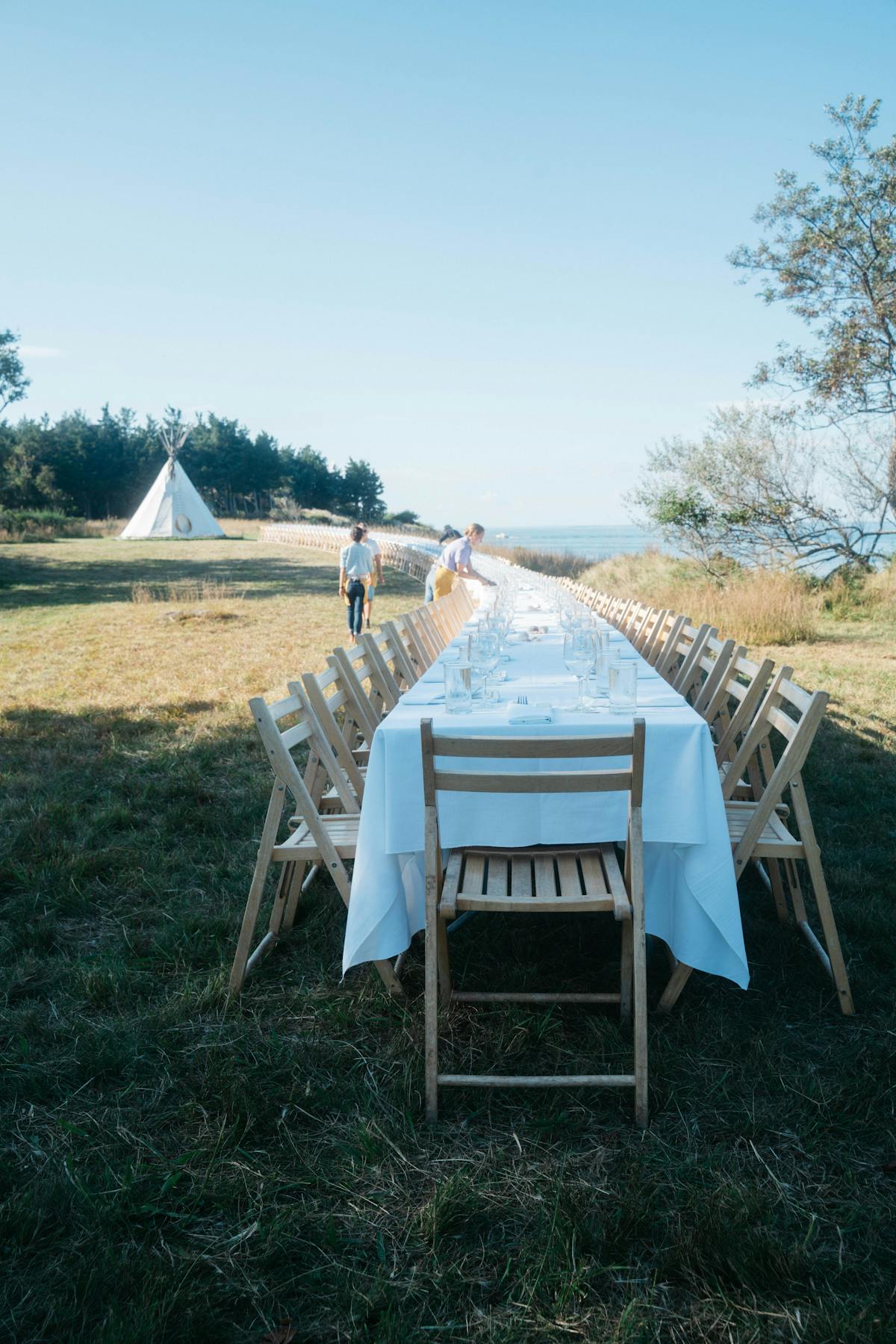 a group of lawn chairs sitting on top of a grass covered field