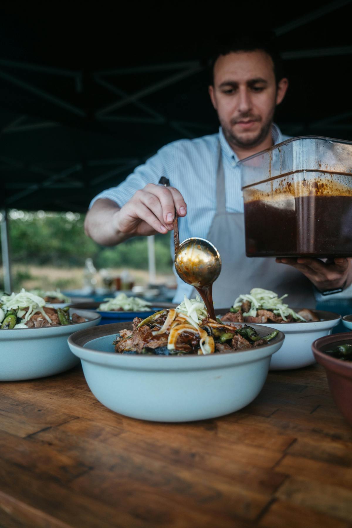 a person standing in front of a bowl of food