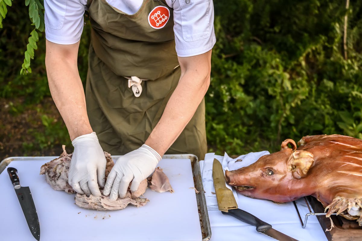 a man cutting pork