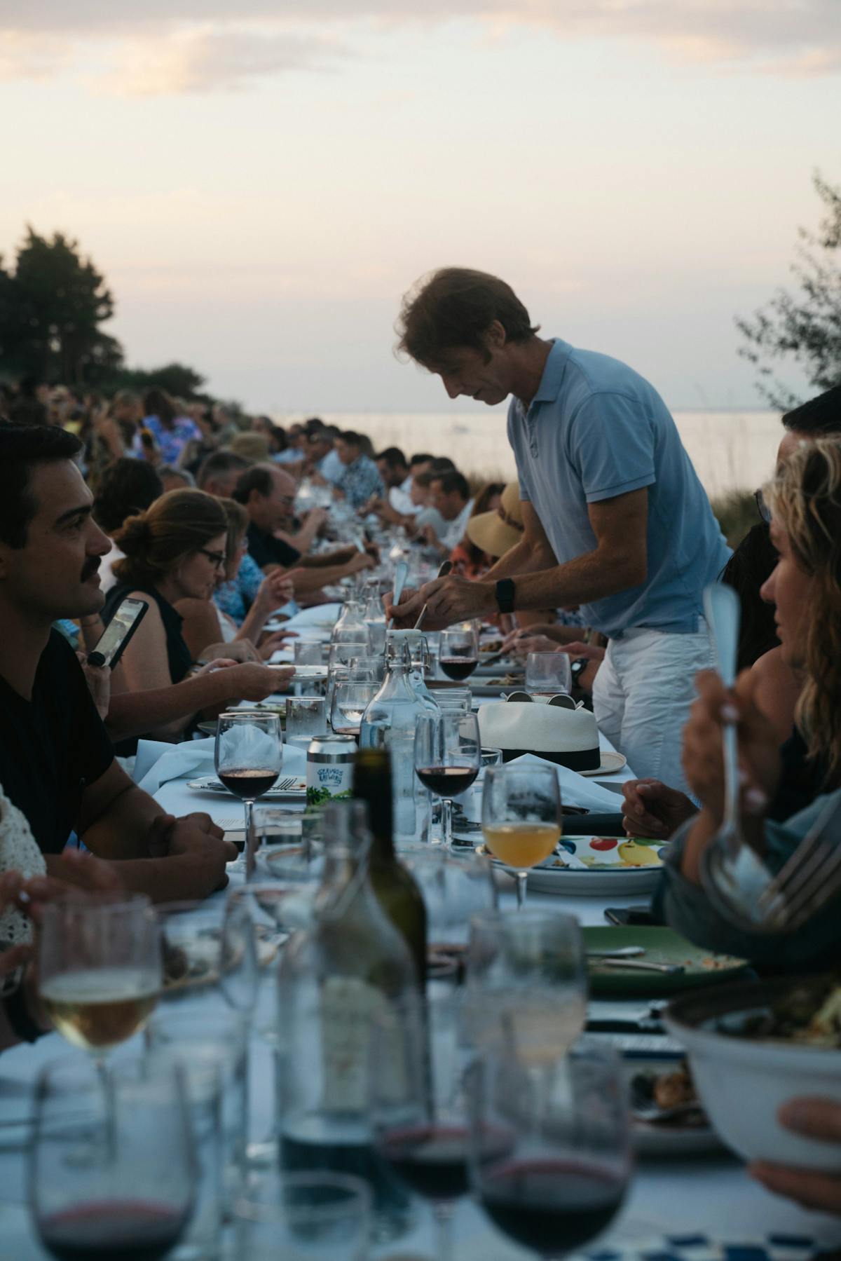 a group of people sitting at a table with wine glasses