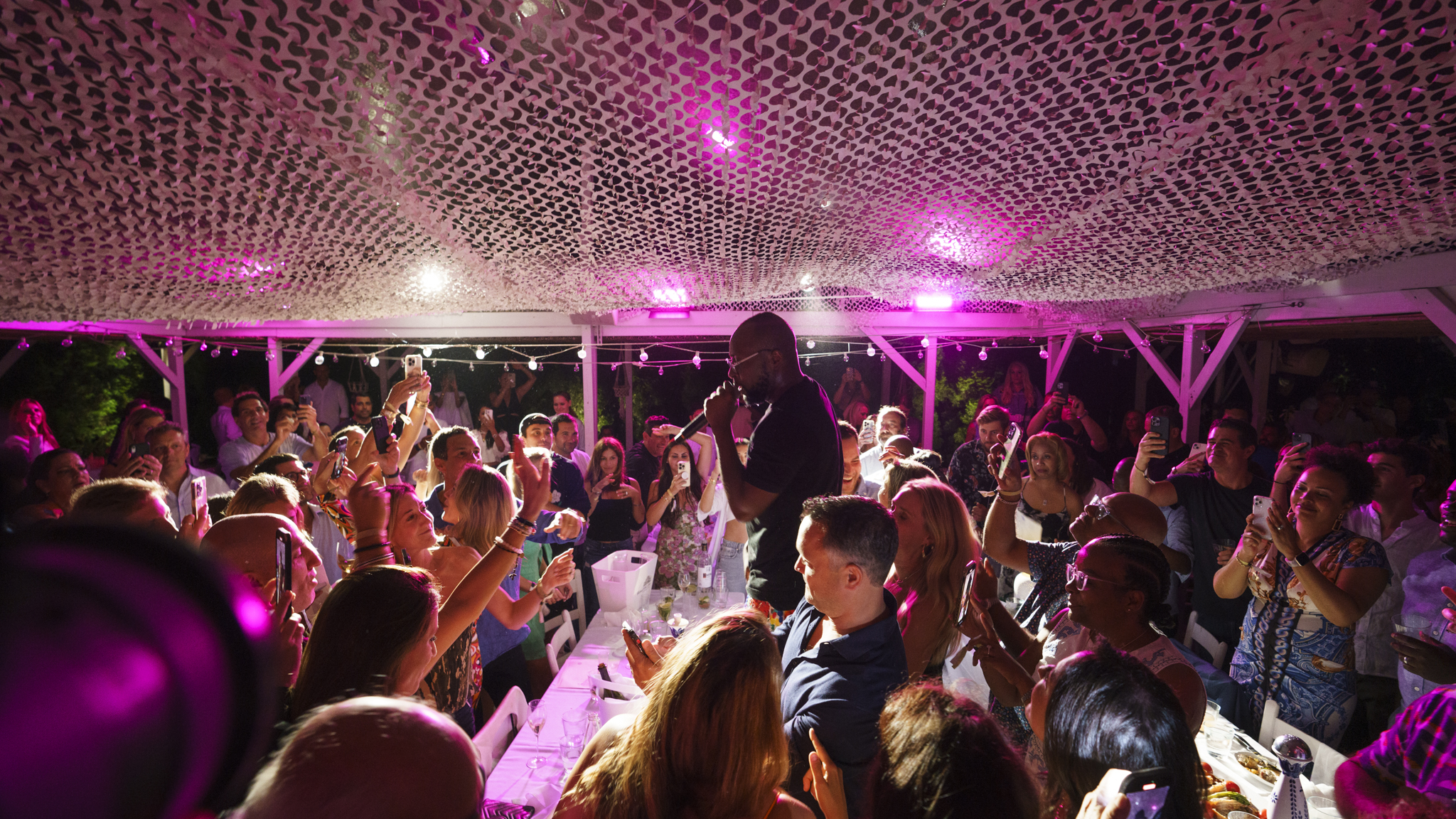 a group of people on a stage in front of a crowd