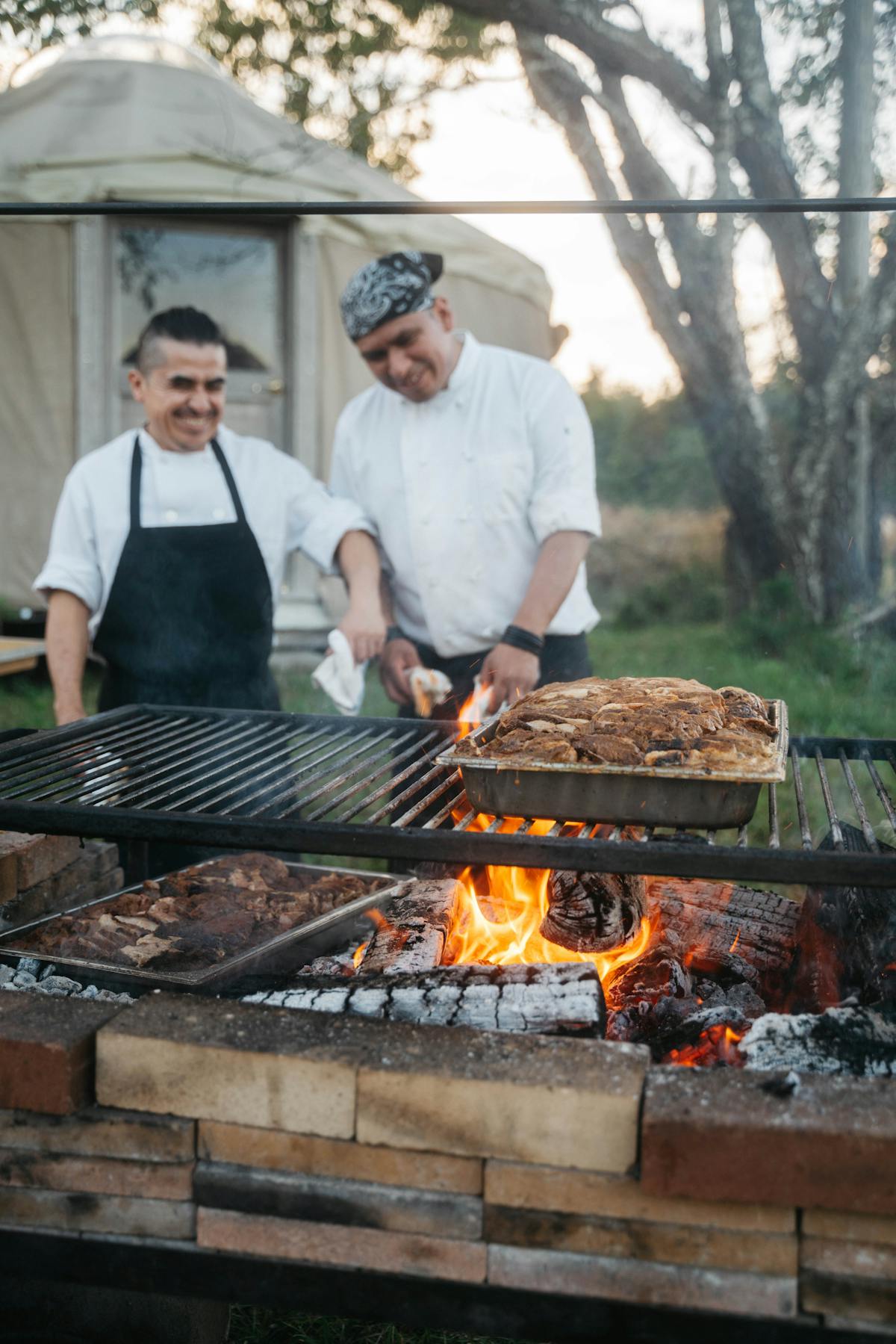 a man and a woman standing on a grill