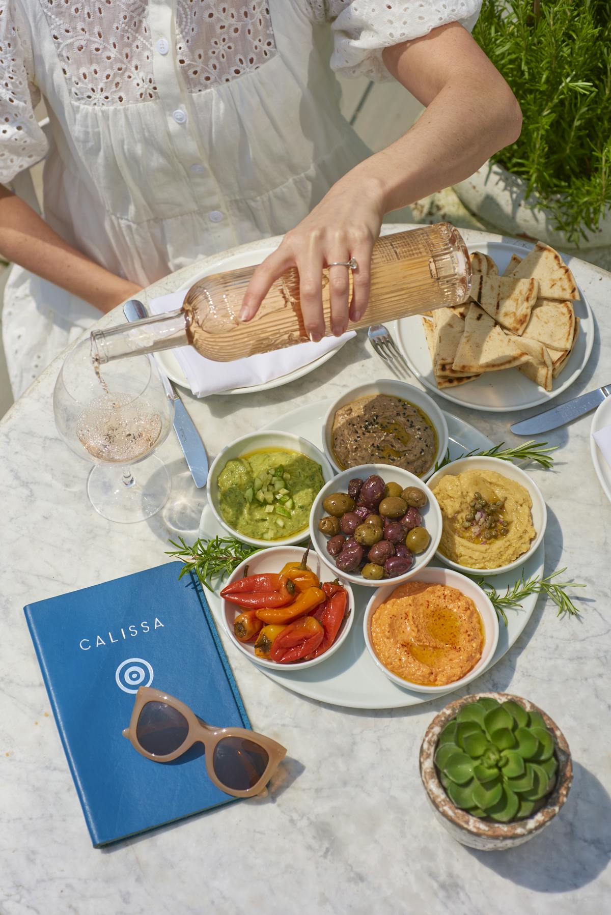 a woman sitting at a table with a plate of food