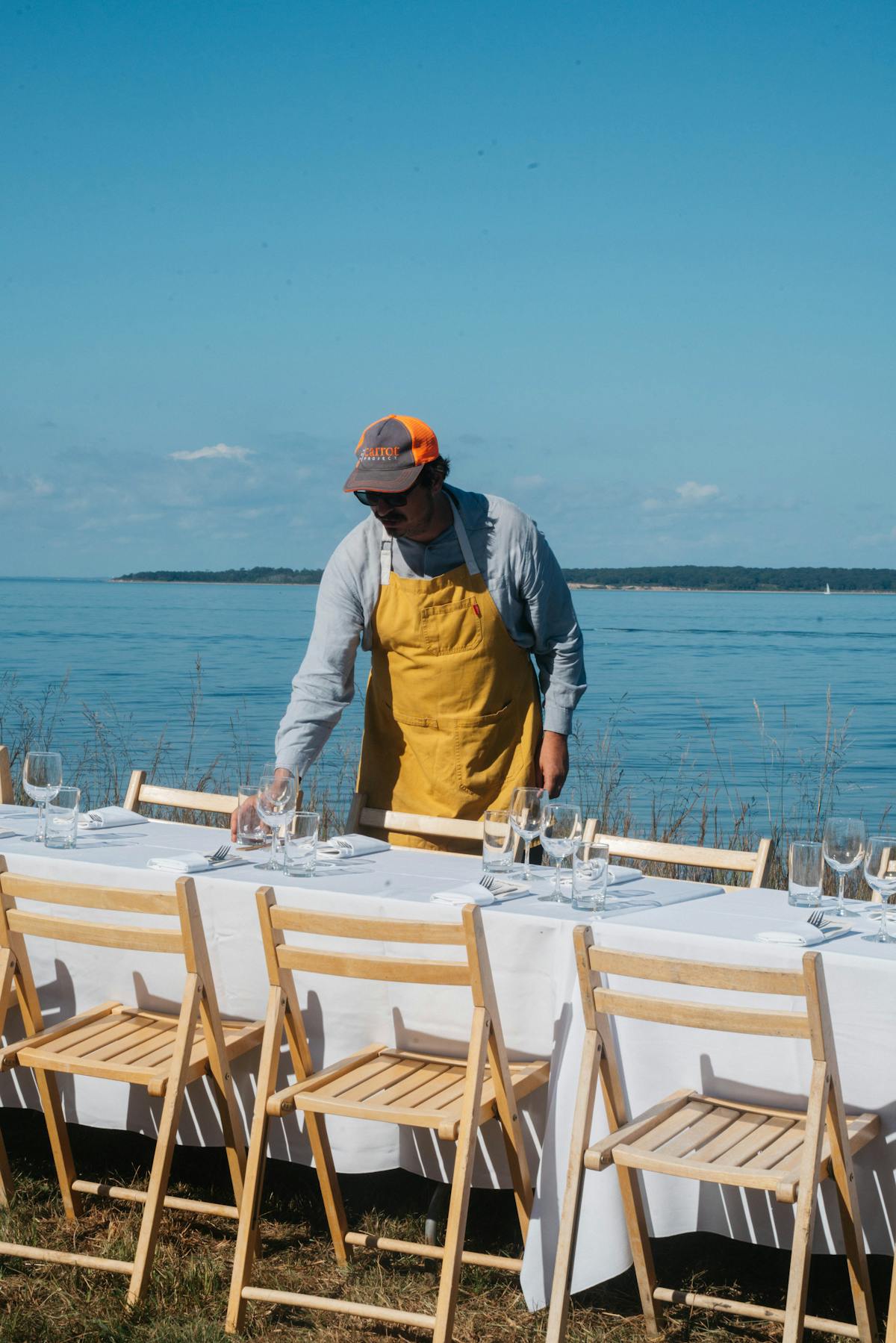 a man sitting in a chair in front of a body of water
