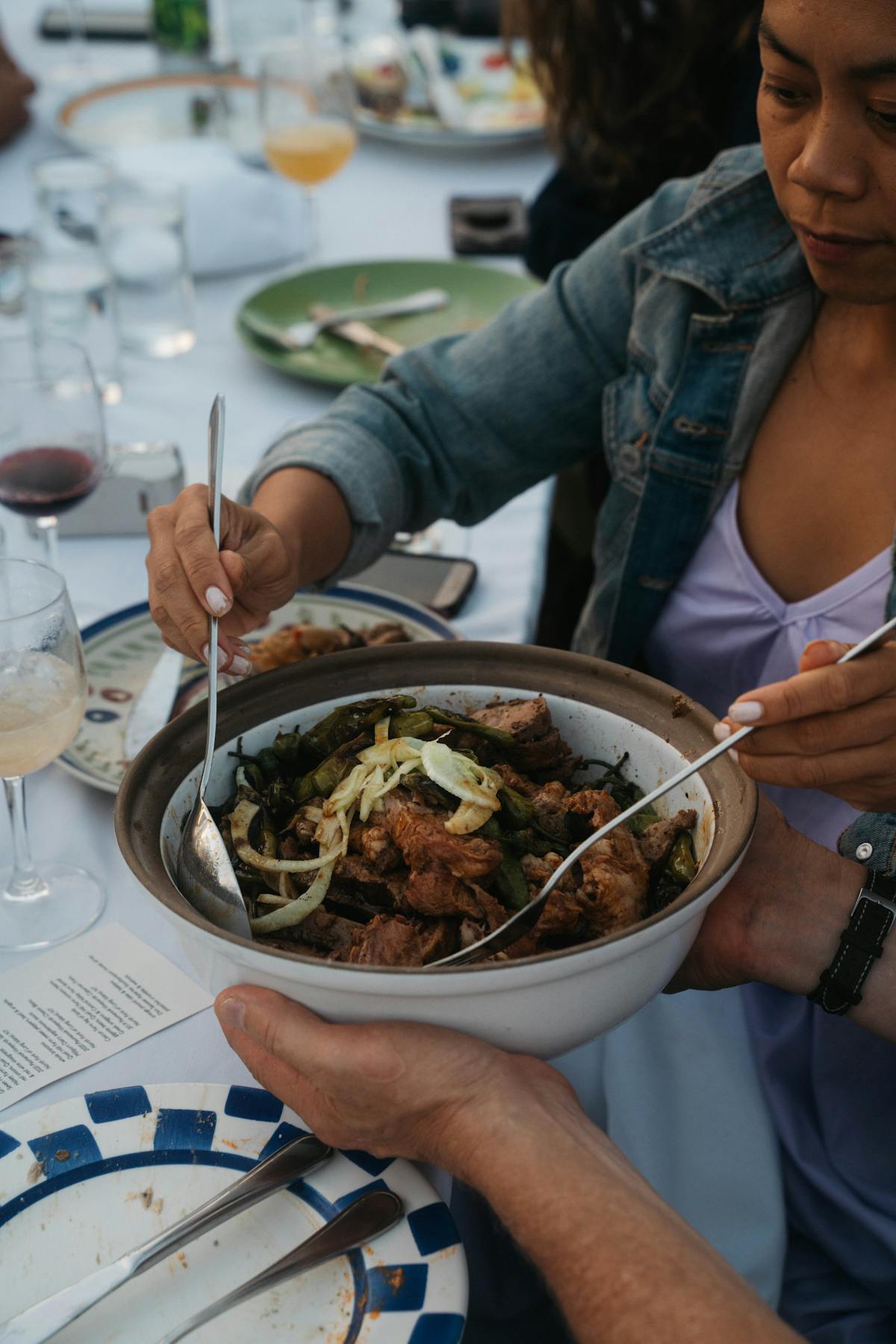a woman sitting at a table with a plate of food