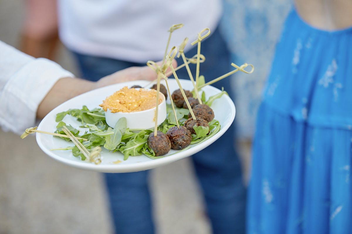 a person sitting at a table with a plate of food