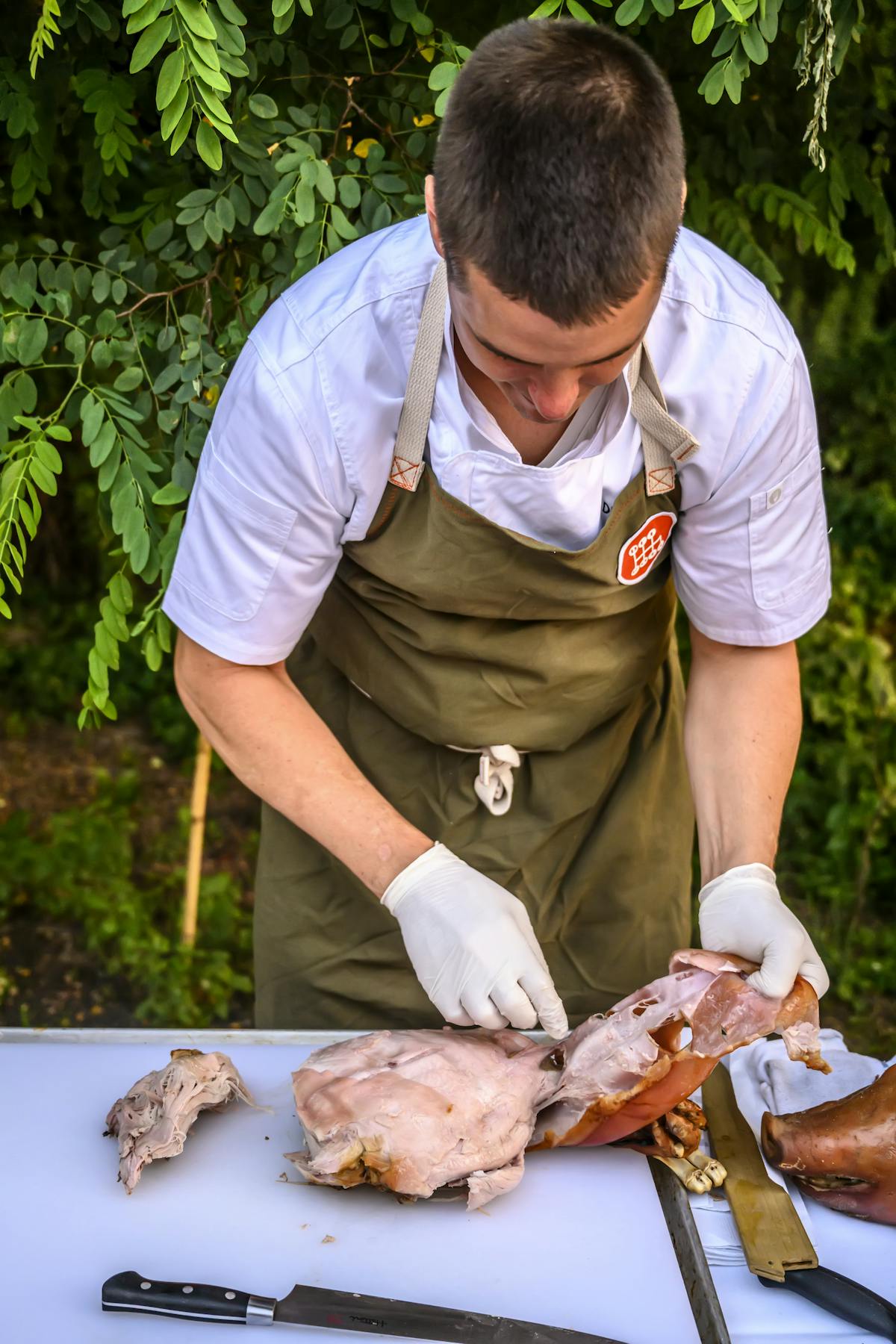 a man cutting pork