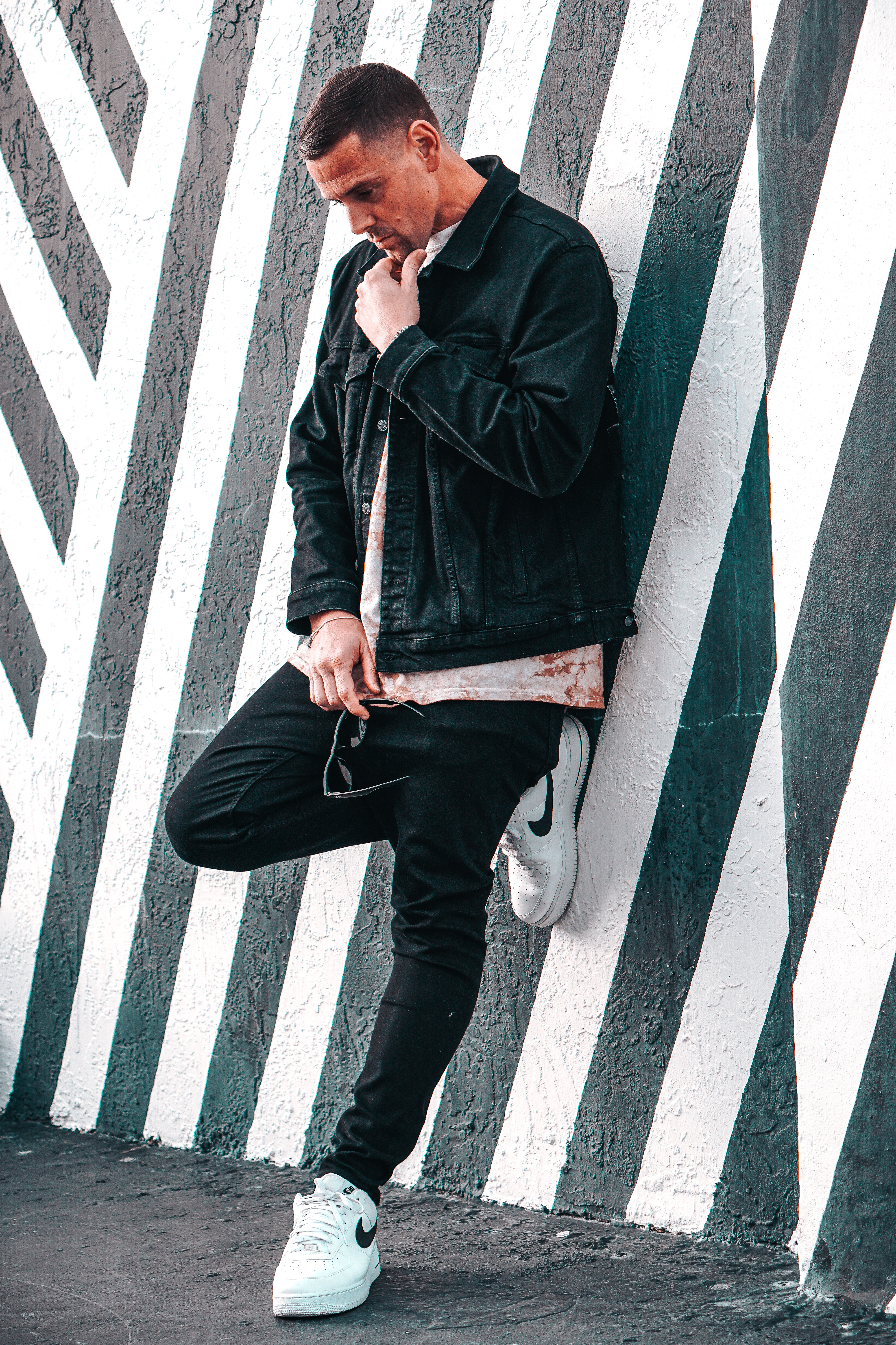 a man leaning against a wall