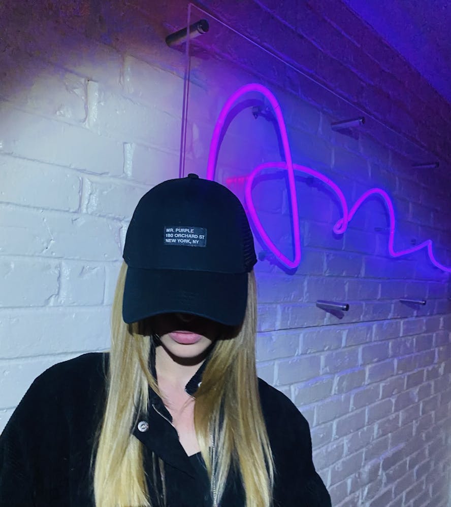 a woman wearing a hat and sunglasses