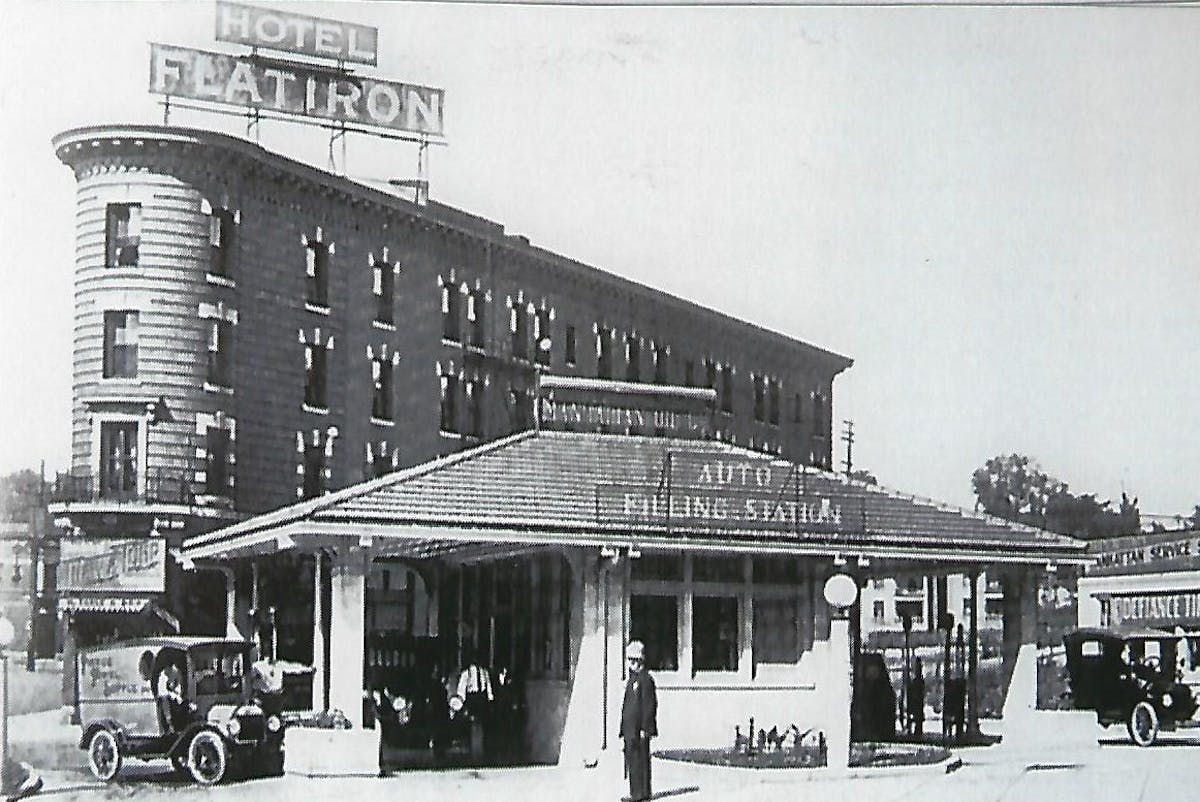 a vintage photo of a group of people standing in front of a building