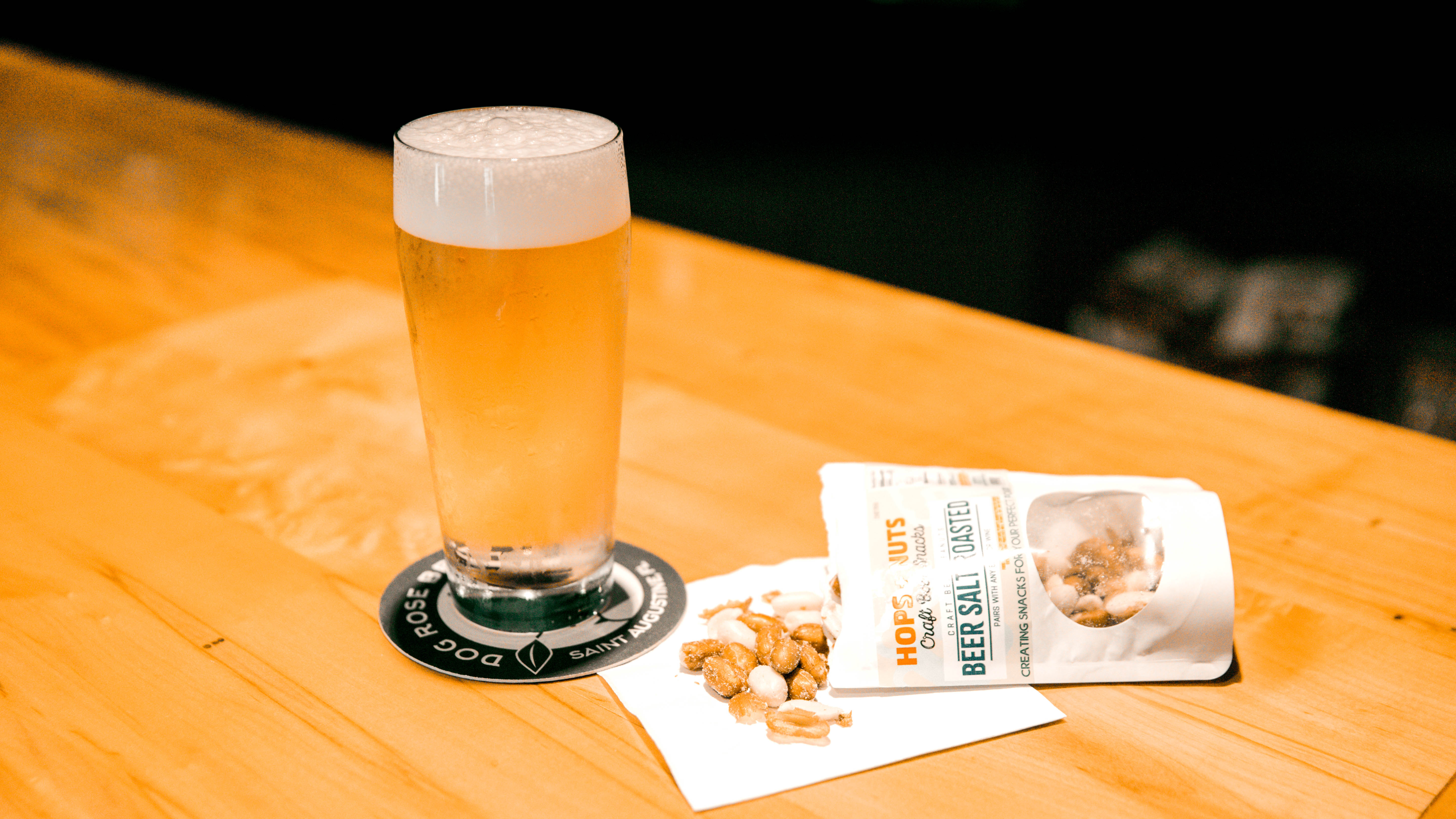 a cup of coffee sitting next to a glass of beer on a table