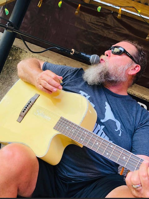 a man holding a guitar