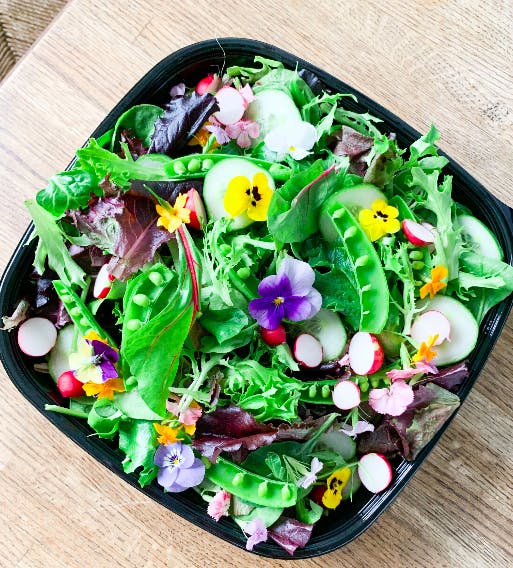 a salad sitting on top of a wooden table