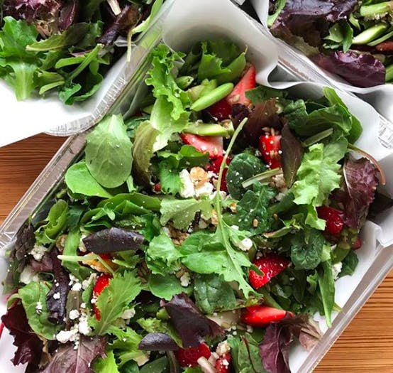 a salad sitting on top of a wooden table