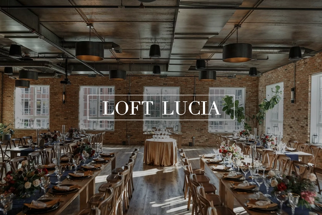 The Loft Lucia logo over an industrial event space
