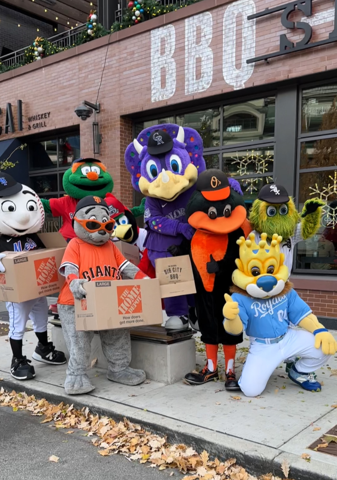MLB mascots holding boxes full of catering donations