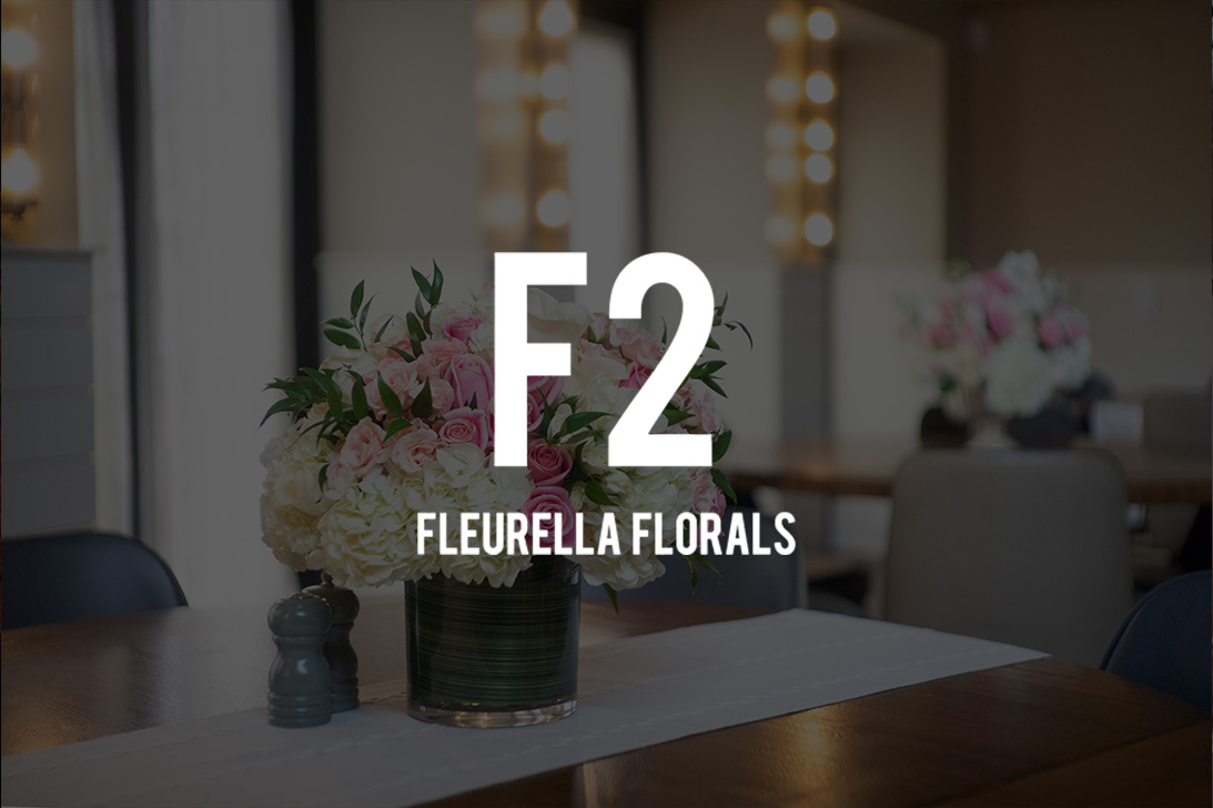 Fleurella logo over a table set with white and pink flowers
