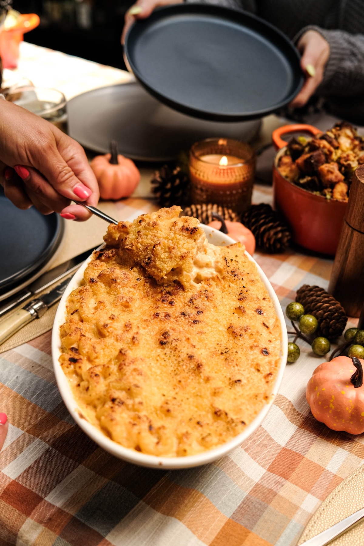 mac and cheese being scooped onto a plate