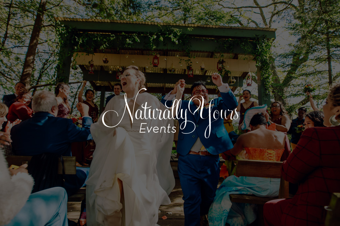 Naturally Yours Events logo over a photo of a couple cheering as they walk down the aisle at their wedding