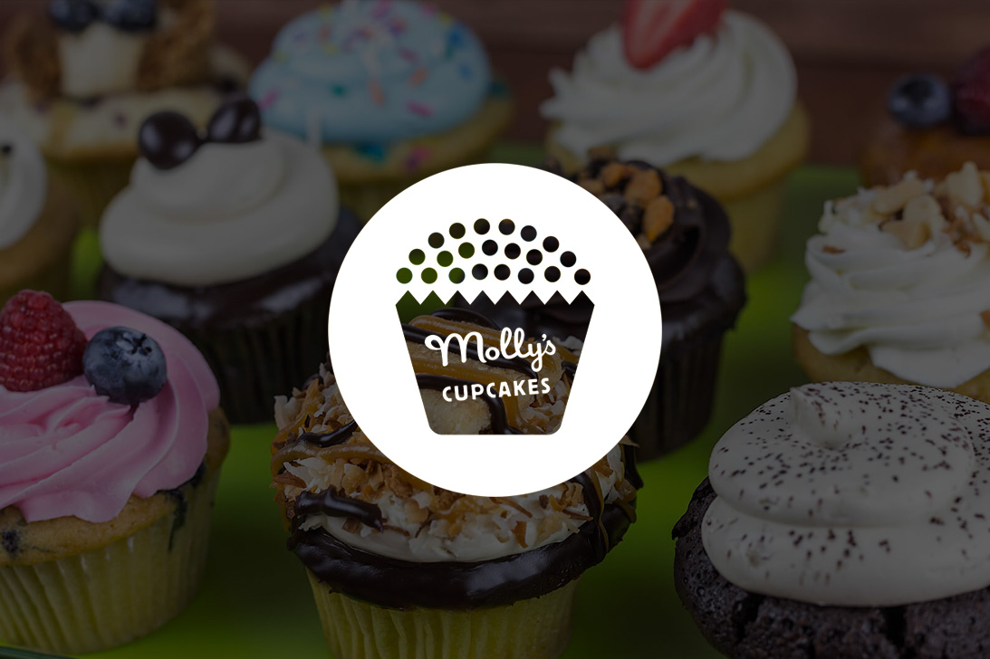 Molly's Cupcakes logo over a photo of a tray full of a variety of cupcakes