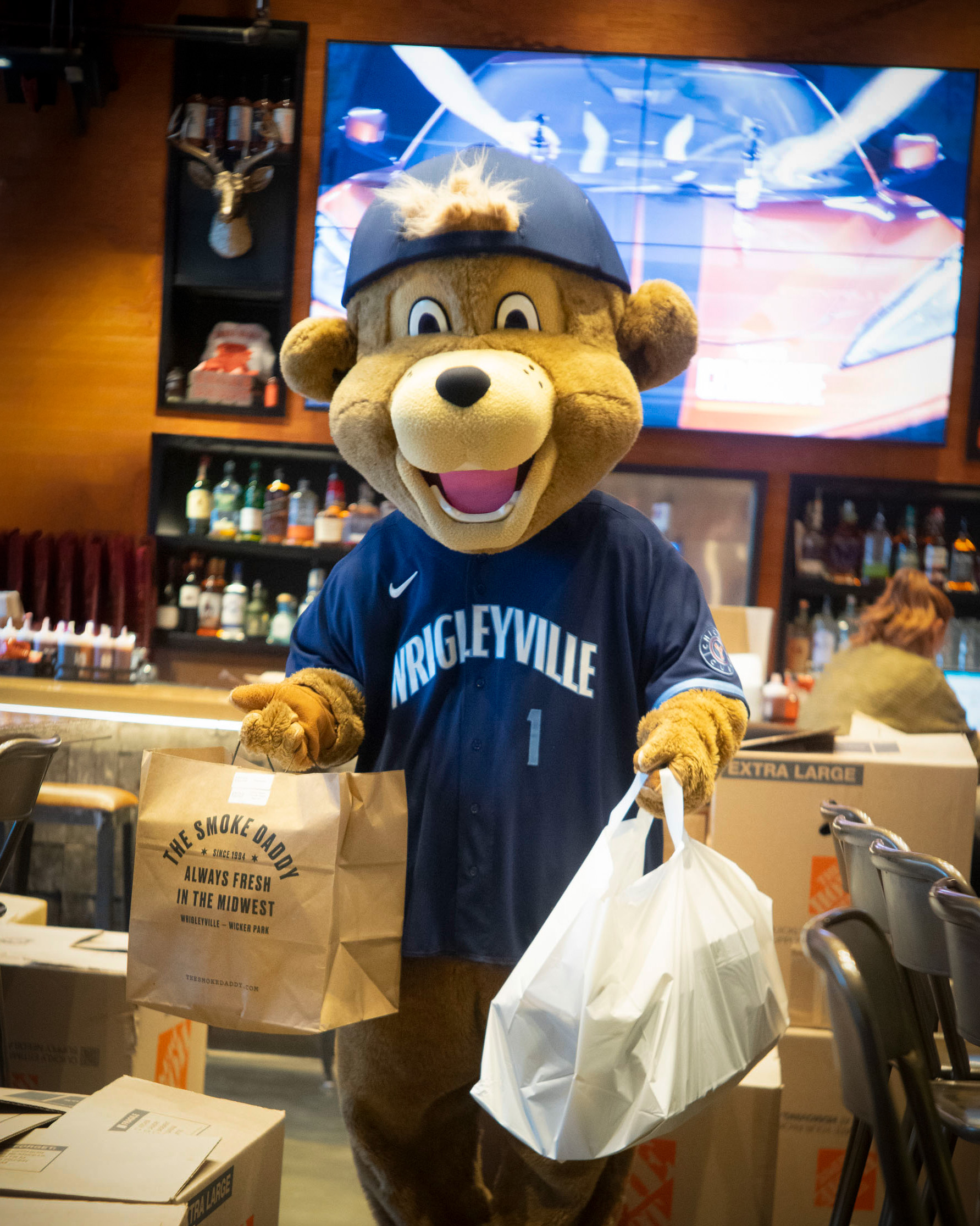Cubs mascot holding catering donations