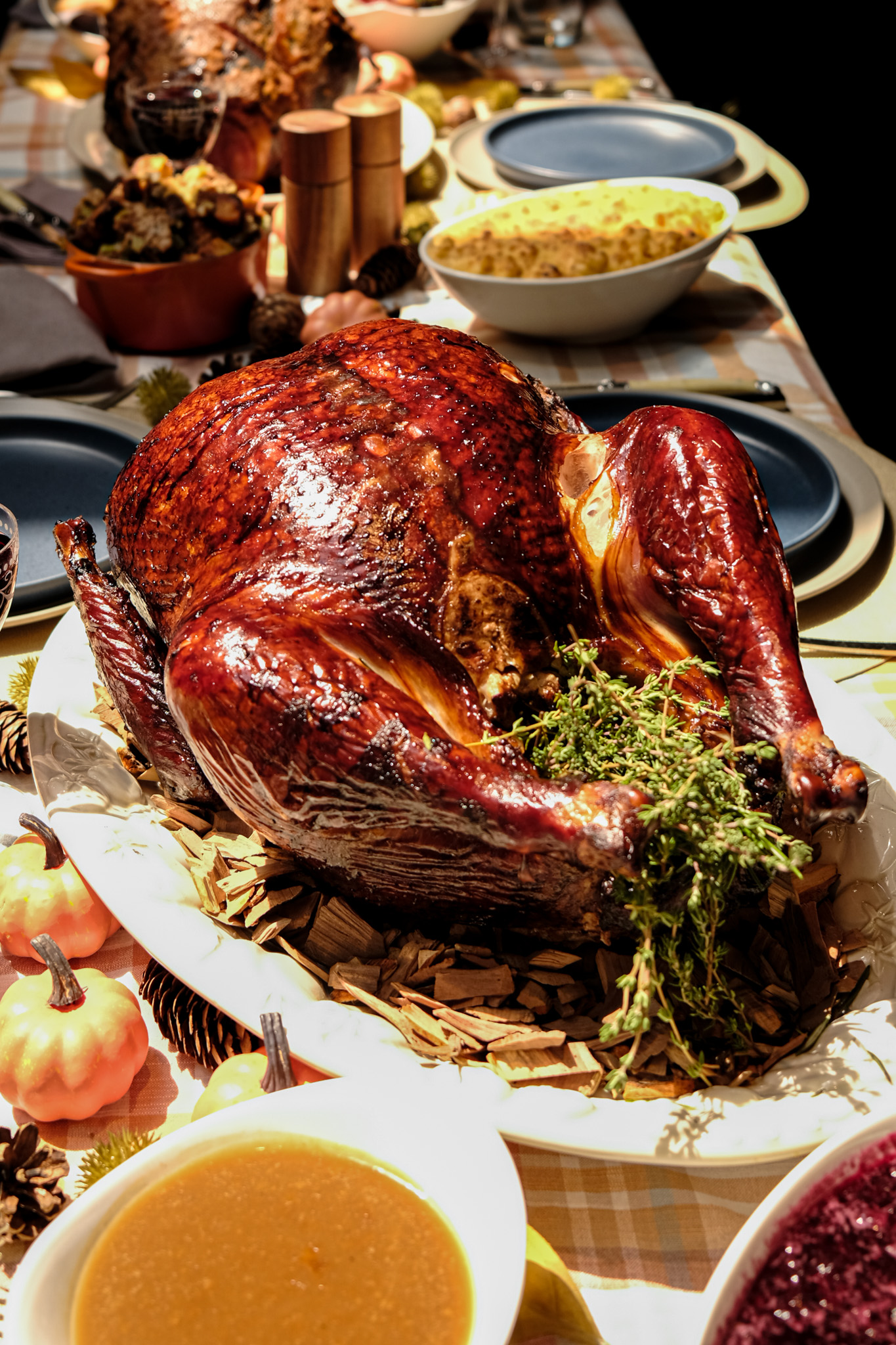 A table seen from above, with a roast turkey and Thanksgiving sides