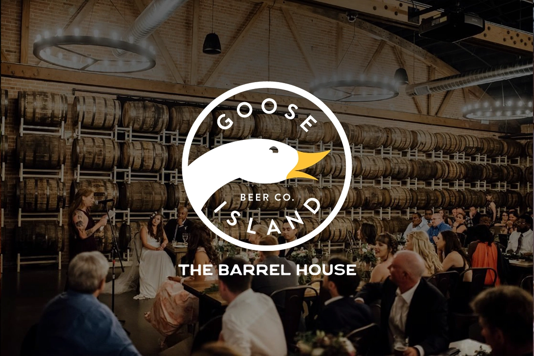 The Goose Island logo over a barrel room that's been converted into an event space