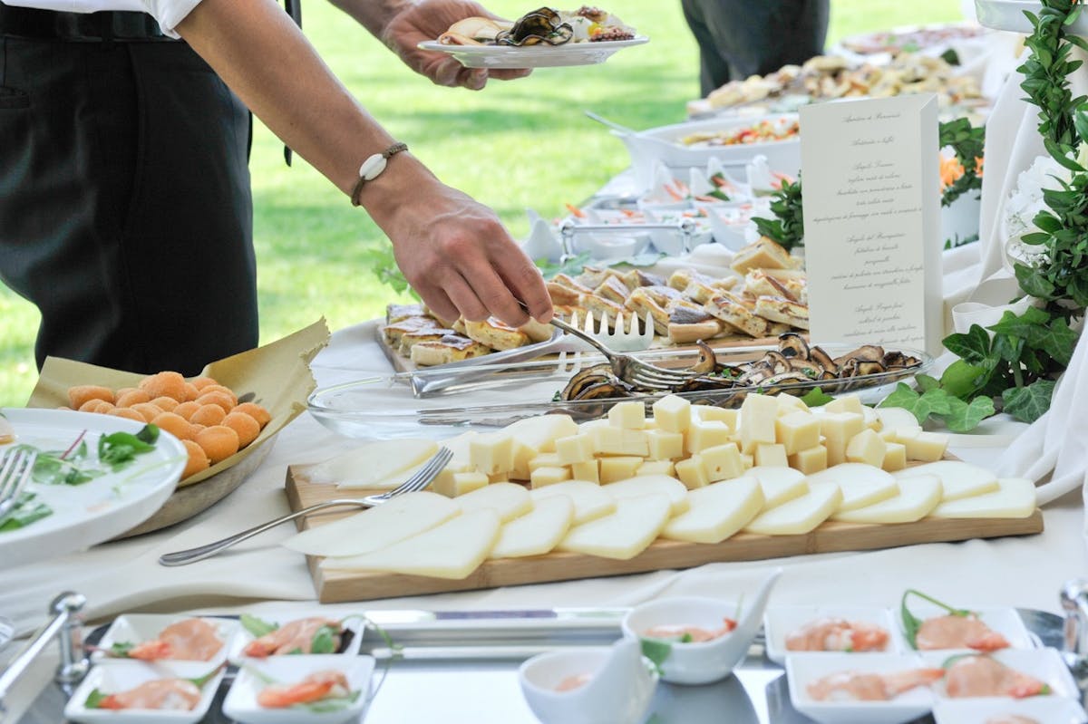 a person sitting at a table with a plate of food
