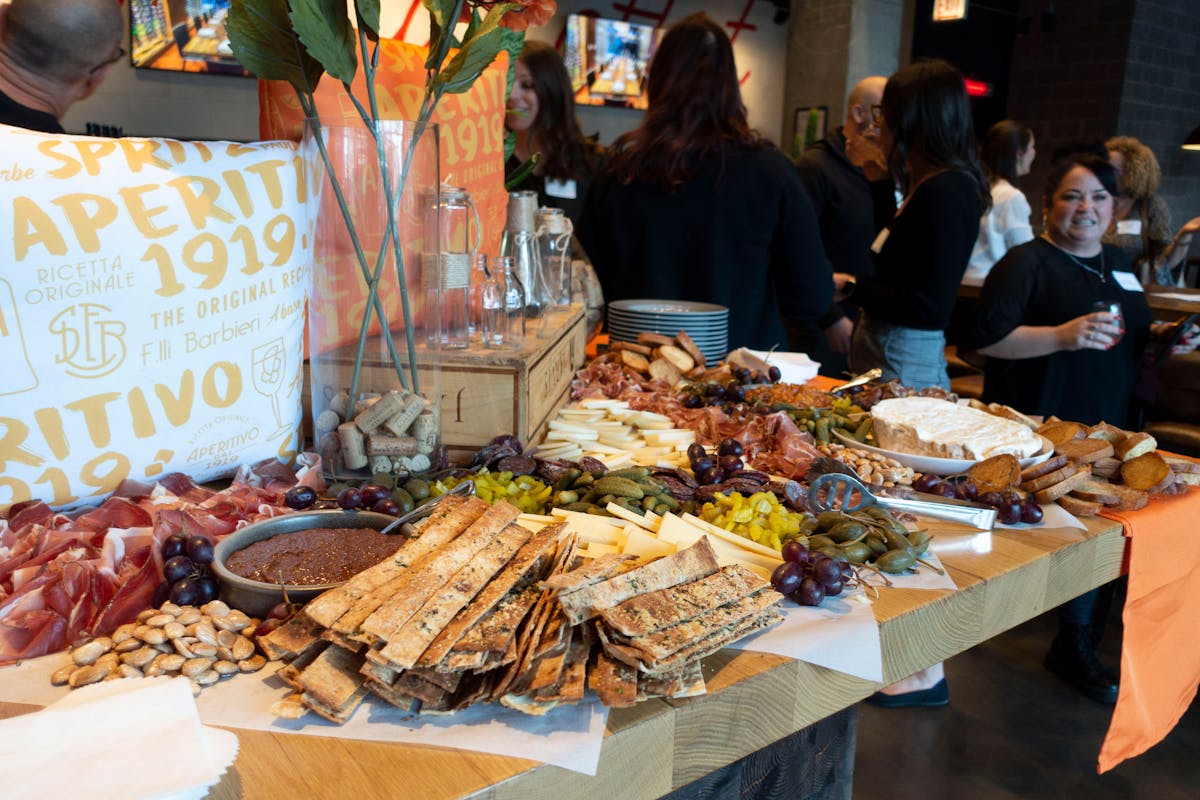 a group of people sitting at a table full of food