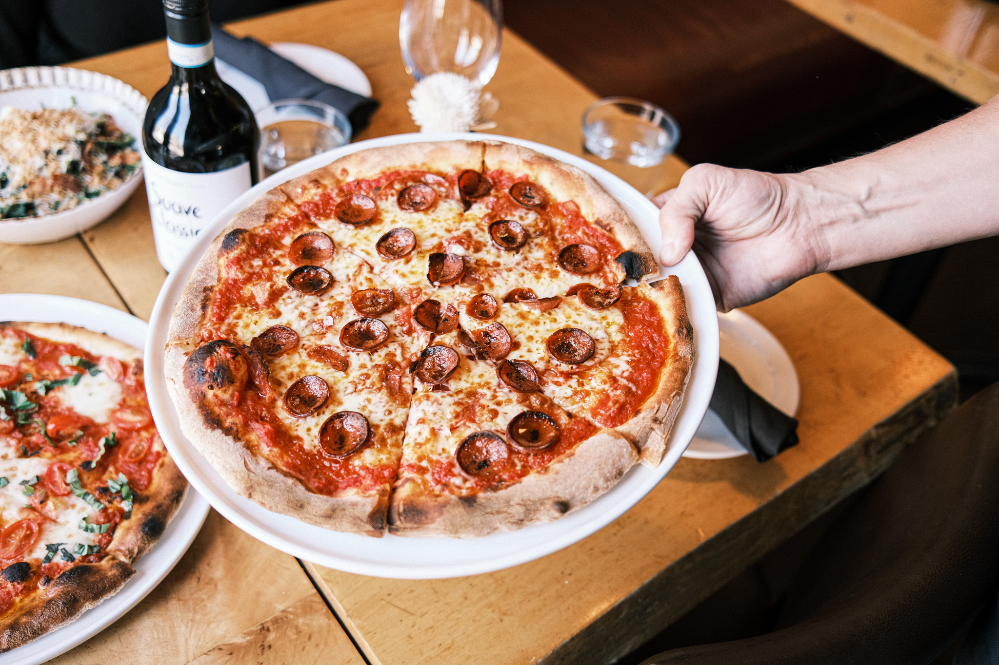 a pizza sitting on top of a wooden table