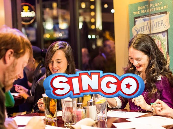a group of people sitting at a table in a restaurant
