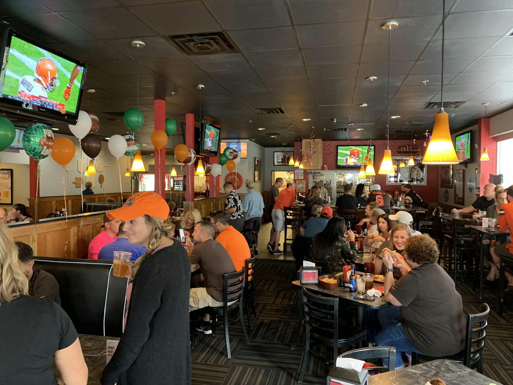a group of people sitting at a table in a restaurant