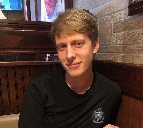 a man sitting at a table posing for the camera