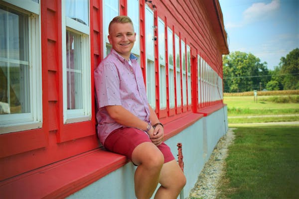 a person sitting on a bench in front of a building