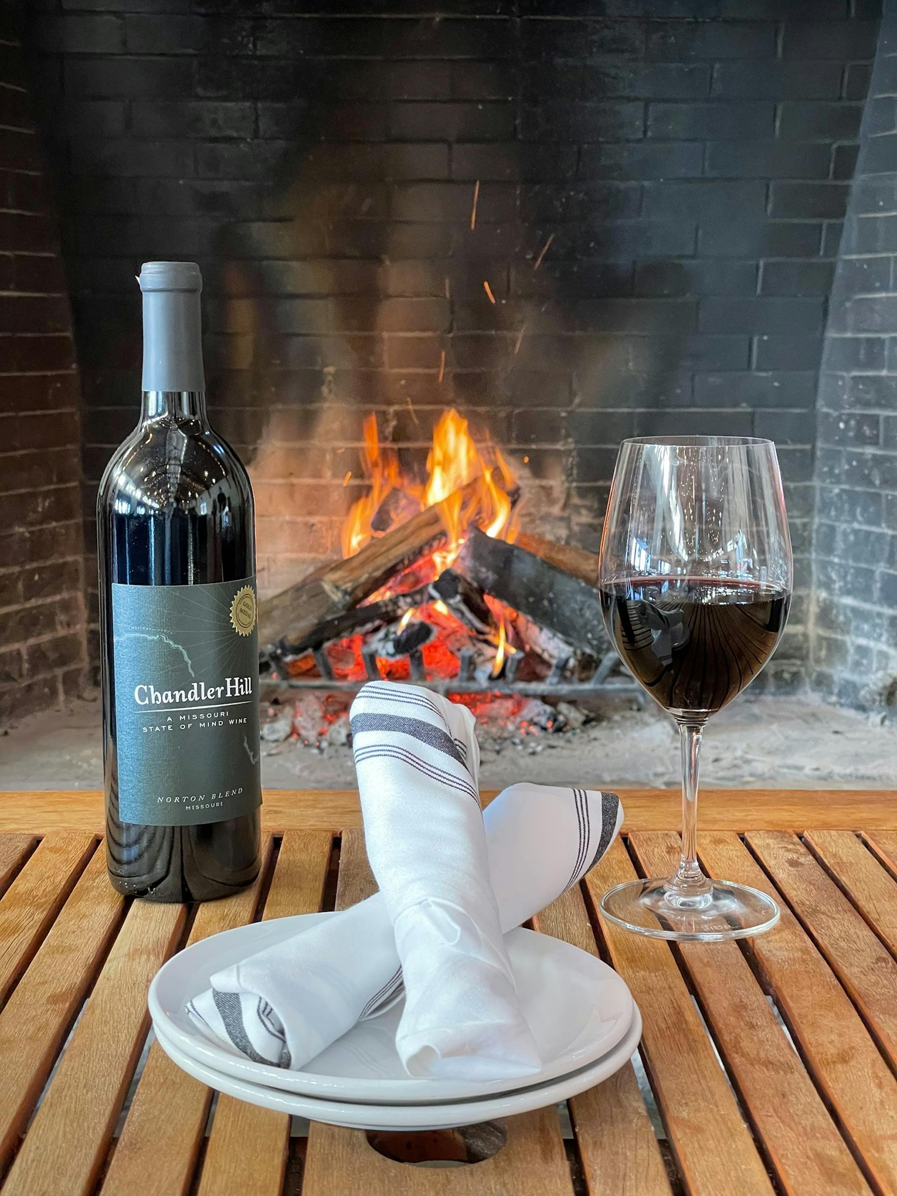 a bottle of wine and a glass of beer on a table