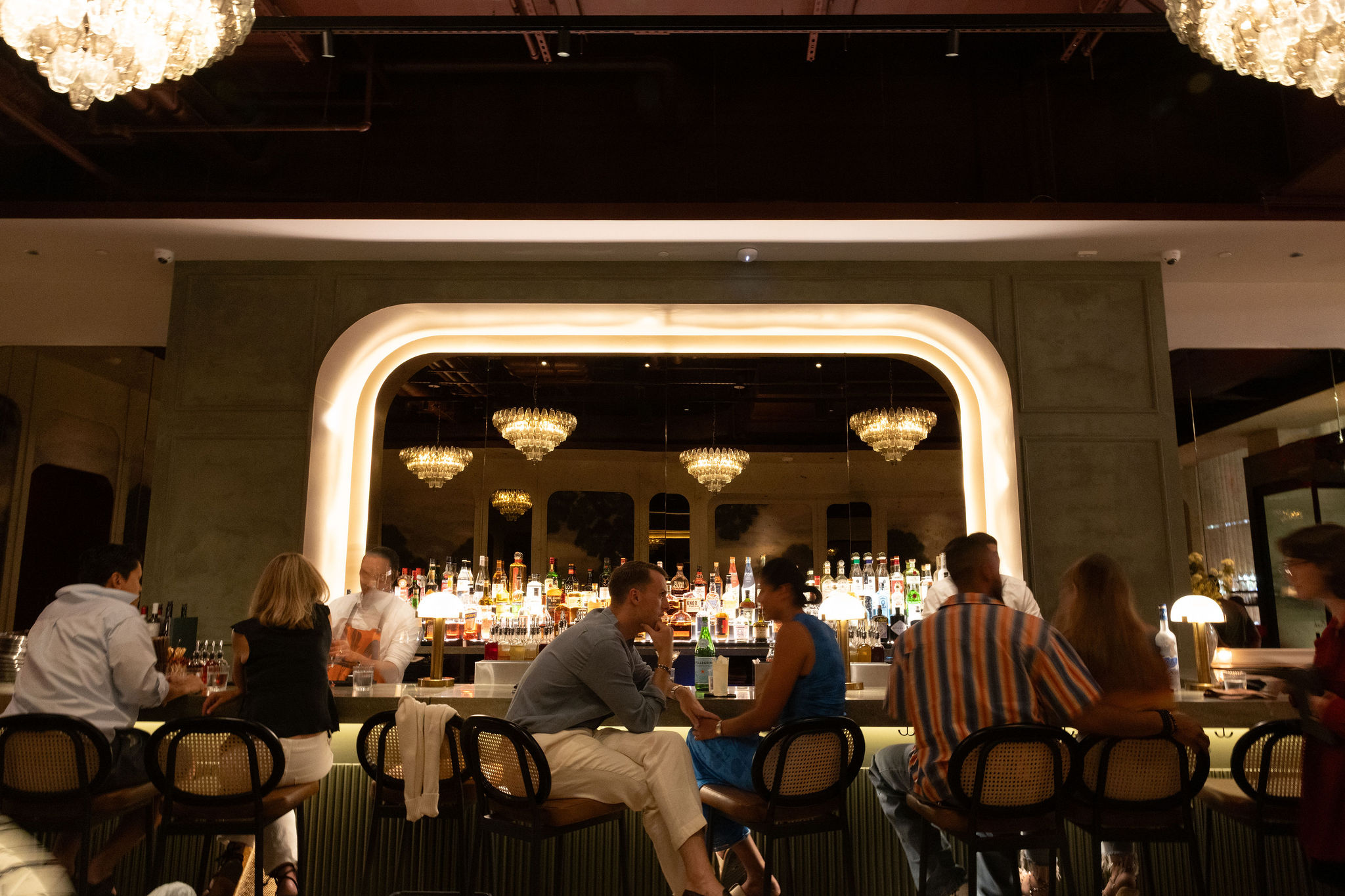 Lively bar scene at Markette Chelsea NYC — featuring crystal chandeliers, elegant design, and an energetic social vibe near Madison Square Garden.