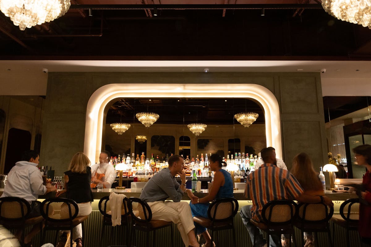Lively bar scene at Markette Chelsea NYC — featuring crystal chandeliers, elegant design, and an energetic social vibe near Madison Square Garden.